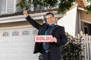Modern home with 'For Sale' sign in front garden