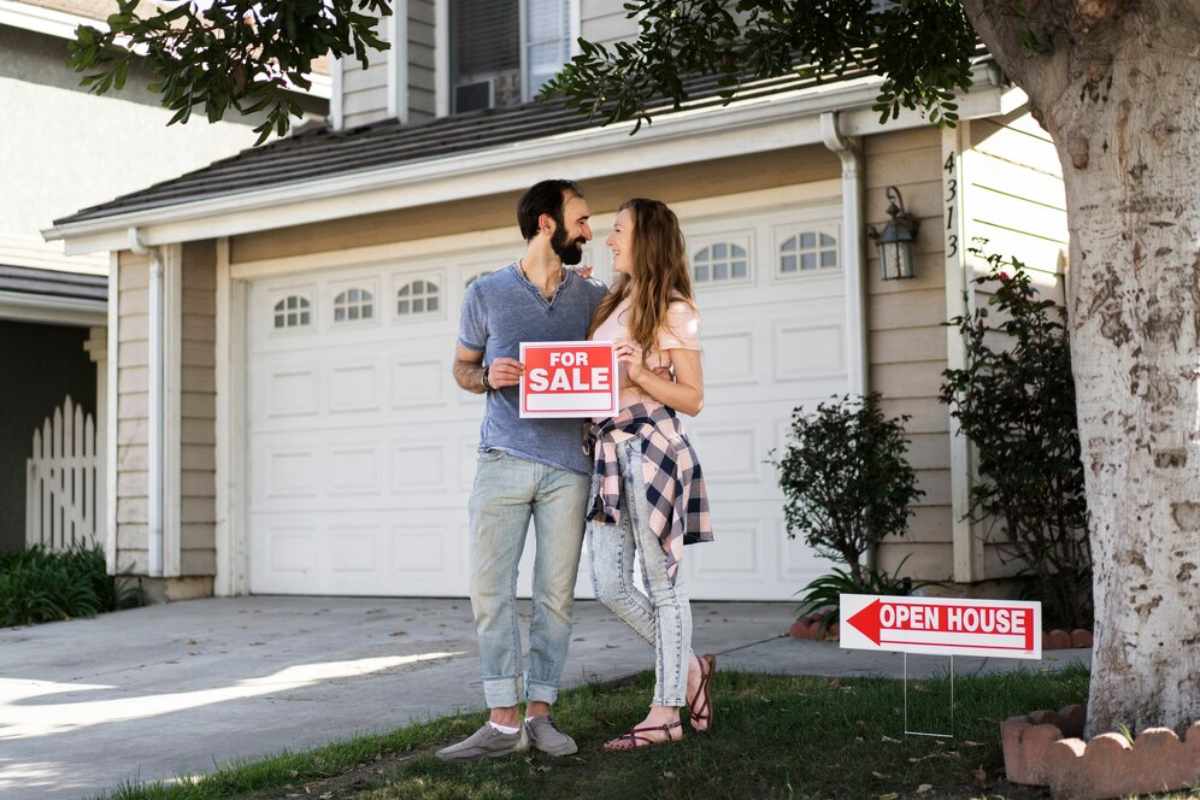 Residential home with for sale sign.