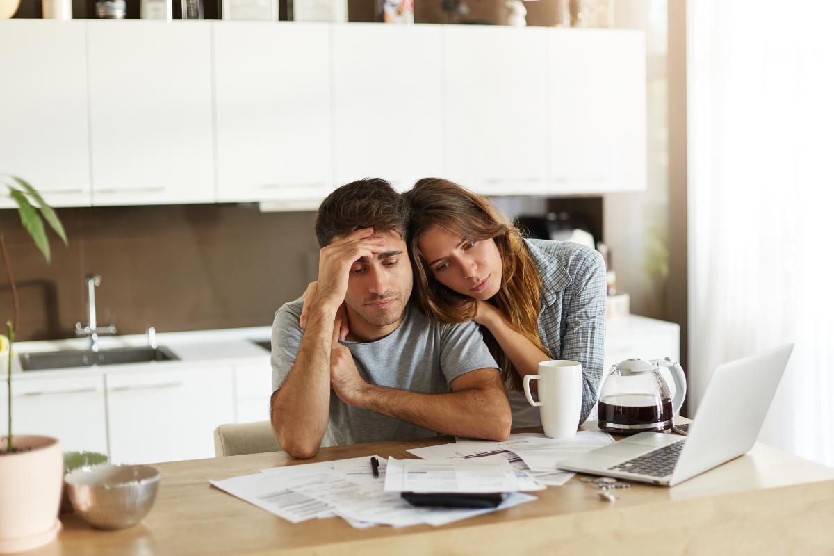 Unmarried couple reviewing legal cohabitation documents at home.
