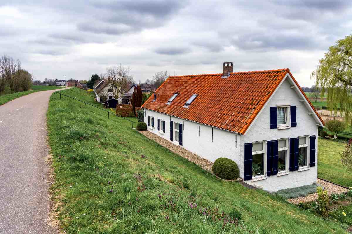 Traditional East Sussex home with "For Sale" sign on front lawn.